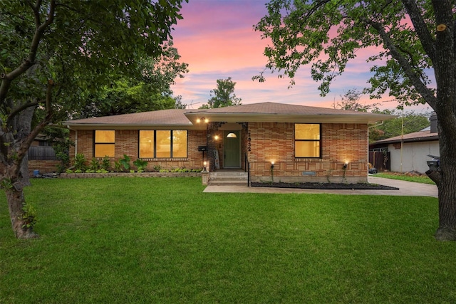 single story home with a front yard and brick siding