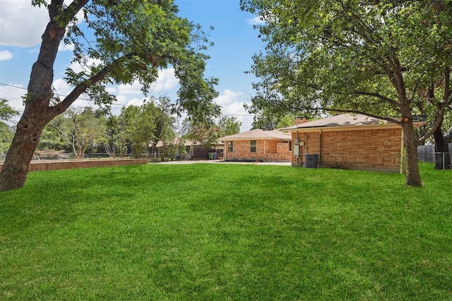 view of yard with cooling unit and fence