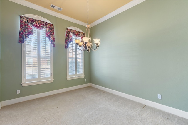 carpeted empty room featuring ornamental molding, a chandelier, visible vents, and baseboards