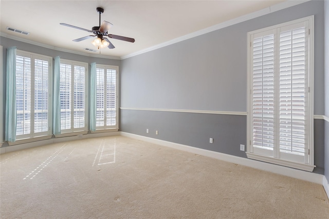 empty room with ornamental molding, visible vents, and light carpet