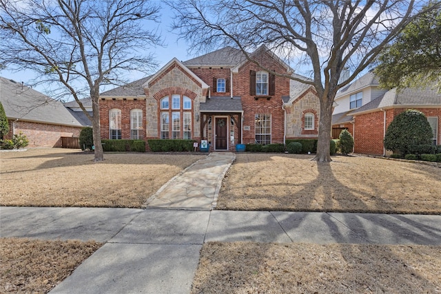 view of front of home with stone siding and brick siding