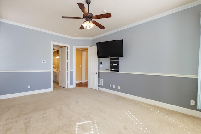 unfurnished bedroom featuring carpet floors, crown molding, visible vents, ensuite bath, and baseboards