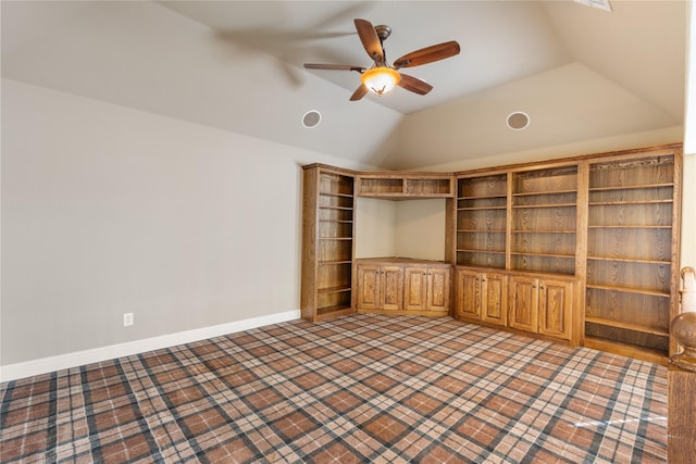 interior space featuring vaulted ceiling, a ceiling fan, and baseboards