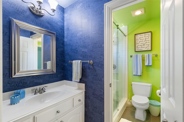 bathroom featuring a stall shower, toilet, tile patterned floors, an inviting chandelier, and vanity