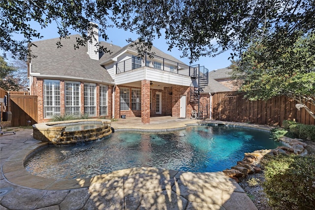 view of pool featuring a pool with connected hot tub, fence, stairway, and a patio