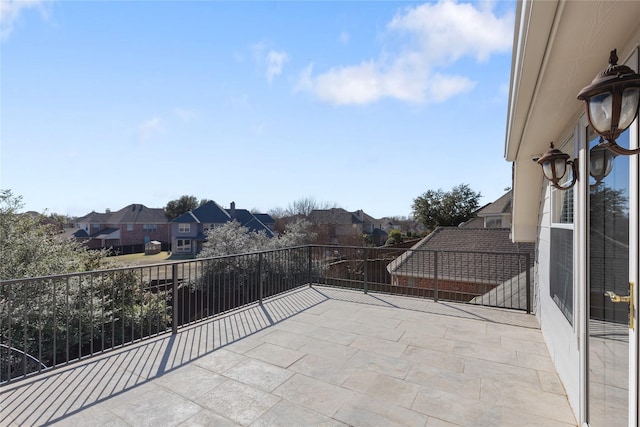 view of patio with a balcony and a residential view