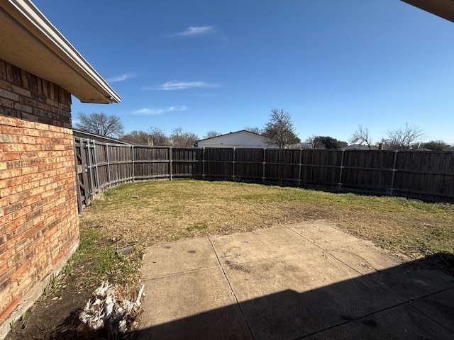 view of yard featuring a patio area and a fenced backyard