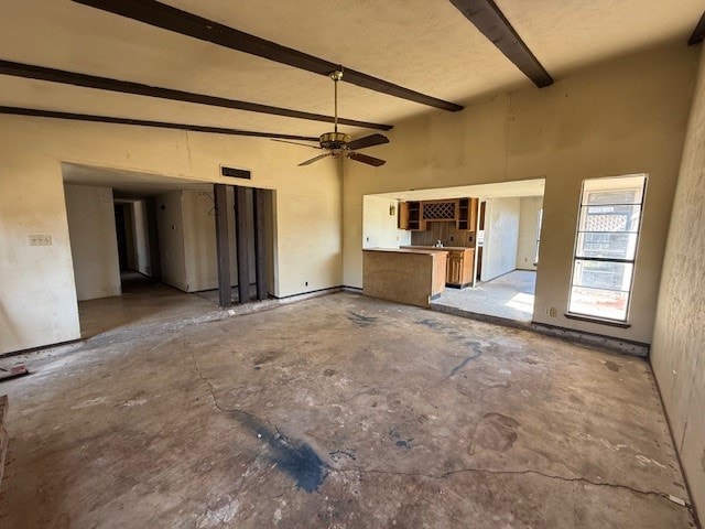 unfurnished living room with ceiling fan, beamed ceiling, and visible vents