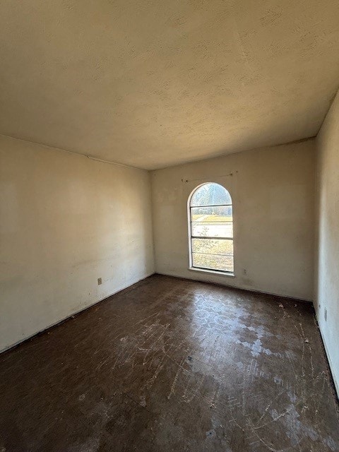 unfurnished room featuring a textured ceiling