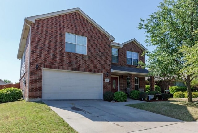 traditional-style house with a garage, driveway, brick siding, and a front lawn