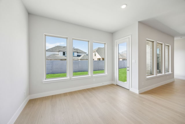 spare room with recessed lighting, light wood-type flooring, and baseboards