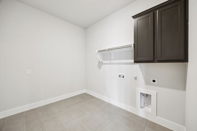 washroom with hookup for an electric dryer, hookup for a gas dryer, washer hookup, baseboards, and cabinet space