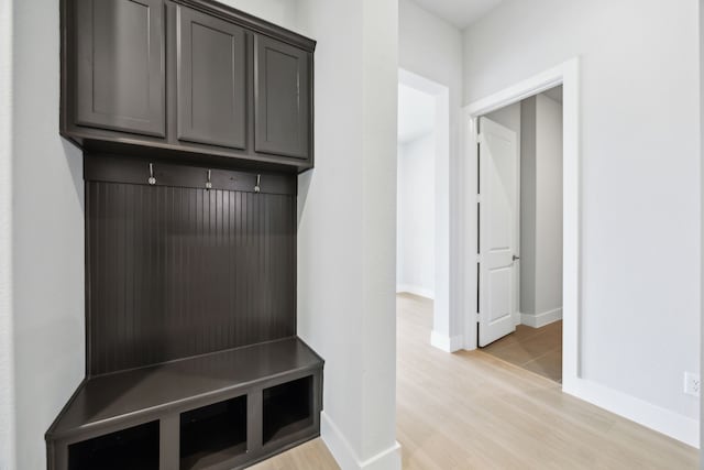 mudroom with baseboards and light wood-style floors