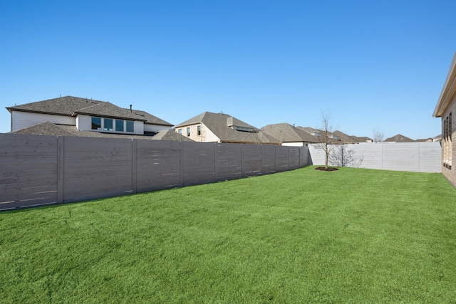 view of yard with a fenced backyard