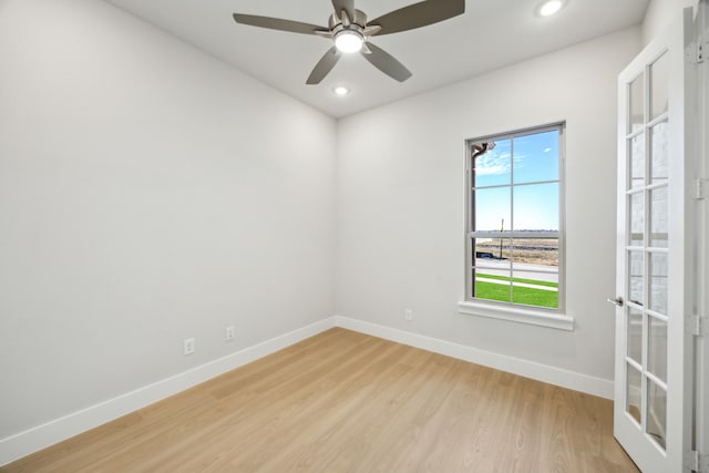 empty room featuring a ceiling fan, recessed lighting, light wood-style flooring, and baseboards