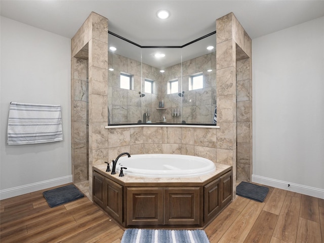 full bath featuring a walk in shower, recessed lighting, wood finished floors, baseboards, and a bath