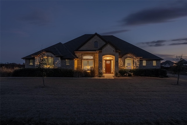 french country style house featuring stone siding