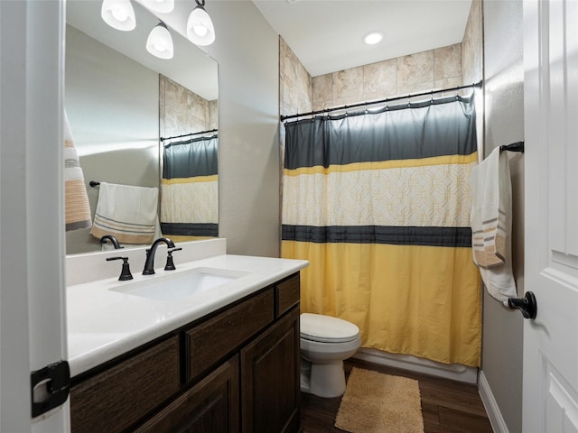 full bathroom featuring vanity, wood finished floors, toilet, and shower / bathtub combination with curtain