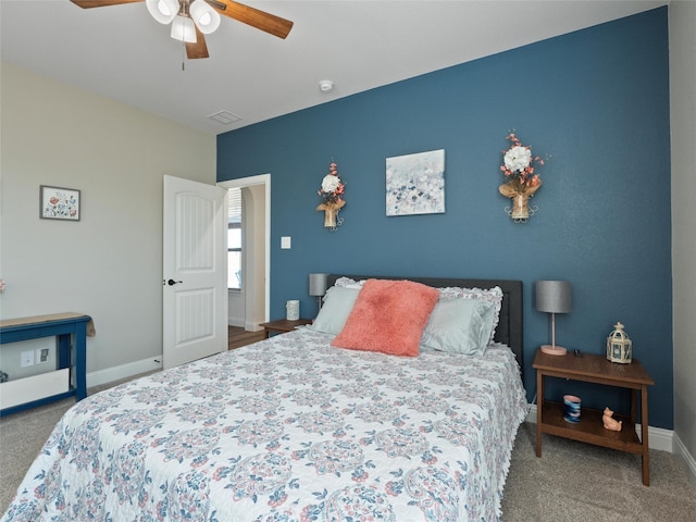 bedroom with carpet floors, baseboards, visible vents, and a ceiling fan