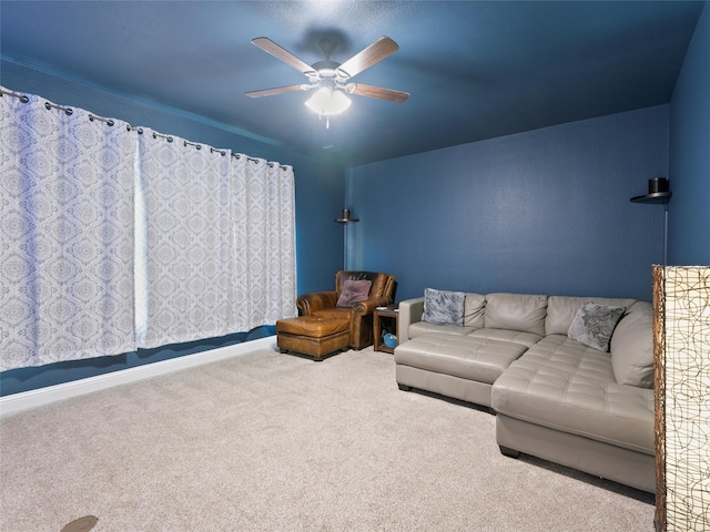 living area with carpet and a ceiling fan