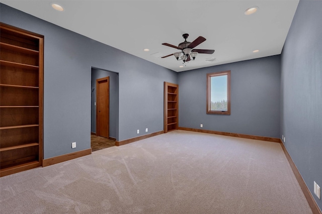 spare room featuring light carpet, baseboards, and recessed lighting