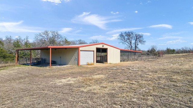 view of pole building featuring fence