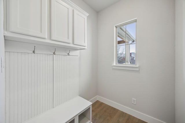 mudroom with dark wood-style floors and baseboards