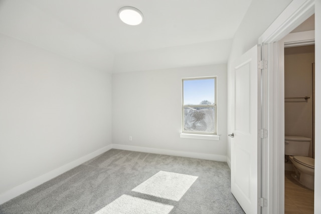 unfurnished bedroom with light colored carpet and baseboards