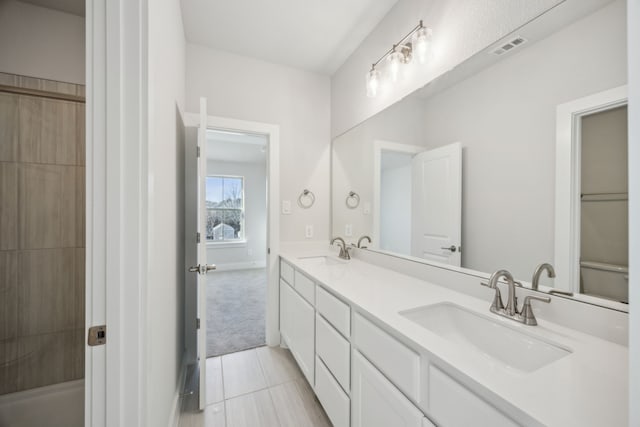 full bathroom with double vanity, tile patterned flooring, a sink, and visible vents