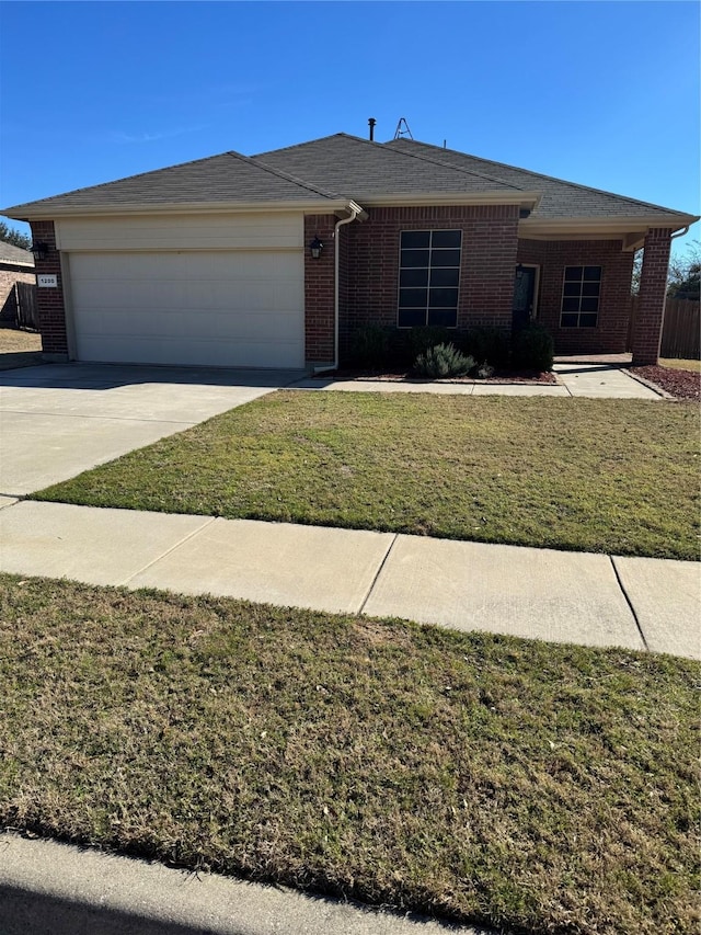 ranch-style house featuring a garage, concrete driveway, brick siding, and a front yard