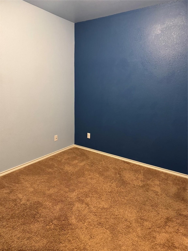 carpeted empty room with baseboards