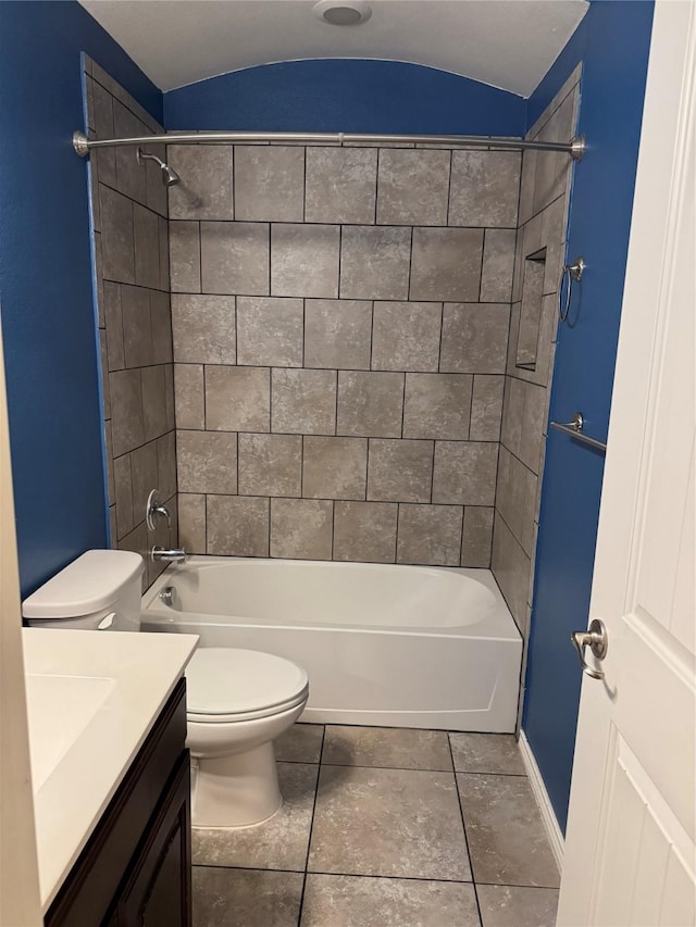 bathroom featuring toilet, bathtub / shower combination, vanity, and baseboards