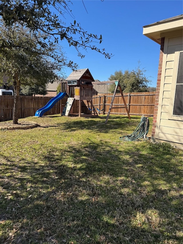 view of play area with a yard and a fenced backyard