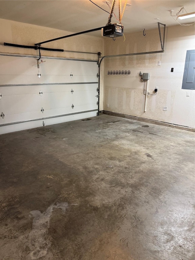 garage featuring electric panel and a garage door opener