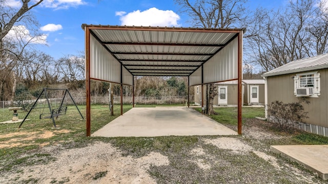 view of parking / parking lot with driveway, fence, cooling unit, and a detached carport