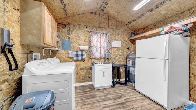 laundry area featuring electric water heater, light wood-style flooring, a sink, washer and dryer, and cabinet space