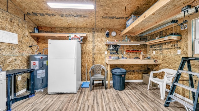 kitchen with freestanding refrigerator, water heater, and wood finished floors