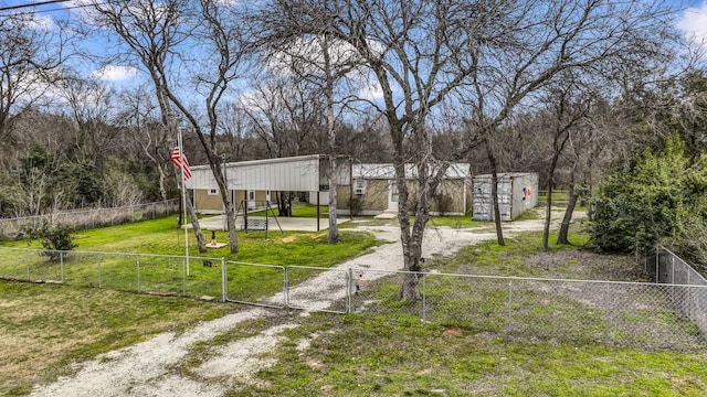 view of yard featuring dirt driveway, fence private yard, and a gate