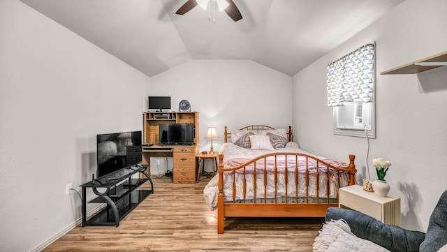 bedroom with light wood finished floors, vaulted ceiling, and a ceiling fan