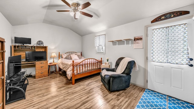 bedroom featuring vaulted ceiling, ceiling fan, and light wood-style floors