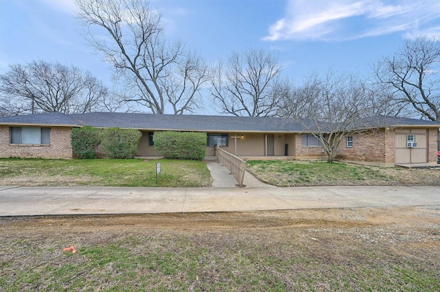 ranch-style house with brick siding and a front yard