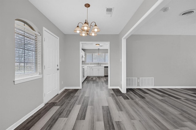 unfurnished dining area featuring visible vents and baseboards