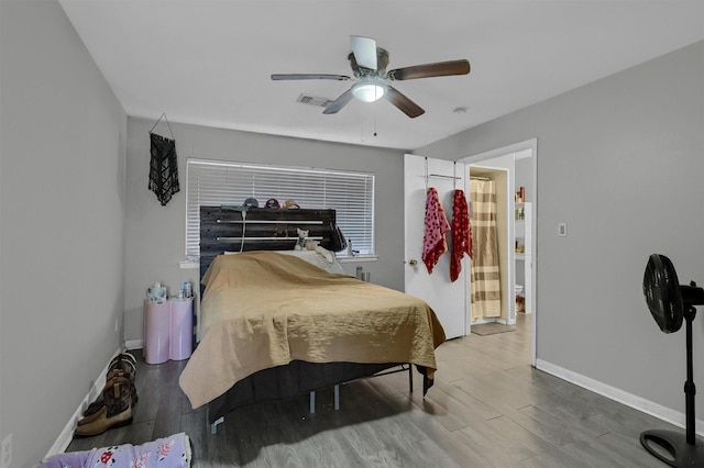 bedroom featuring visible vents, wood finished floors, a ceiling fan, and baseboards