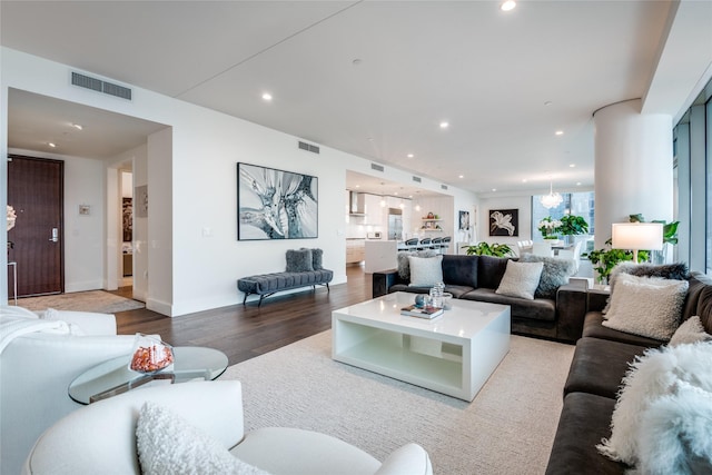 living room featuring recessed lighting, visible vents, and wood finished floors