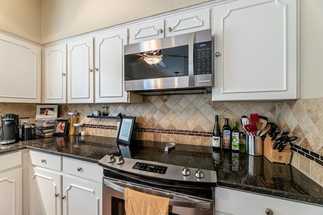 kitchen featuring appliances with stainless steel finishes, white cabinetry, and tasteful backsplash