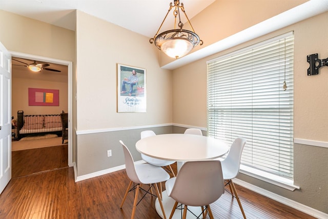 dining room with dark wood-style flooring and baseboards