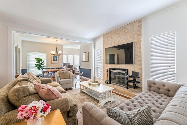 living room featuring a fireplace and an inviting chandelier