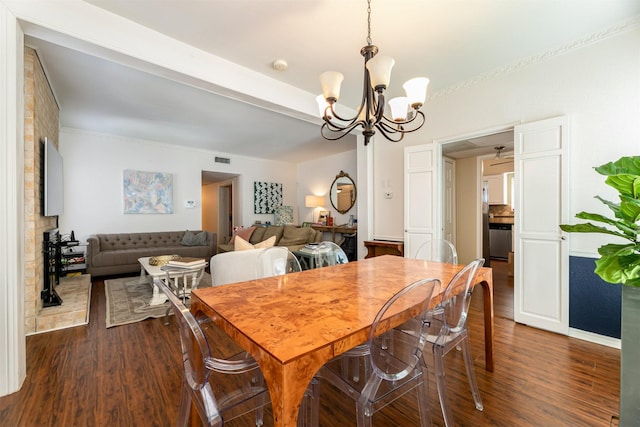 dining room featuring dark wood-style floors, visible vents, a chandelier, and beamed ceiling