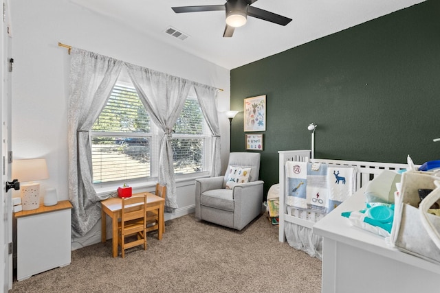 bedroom featuring baseboards, visible vents, a ceiling fan, and light colored carpet