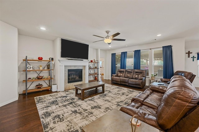 living area with recessed lighting, baseboards, dark wood-type flooring, and a tile fireplace